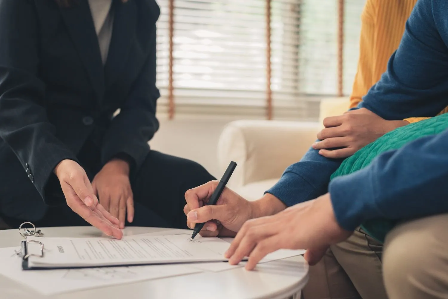 A policy document being signed at a table